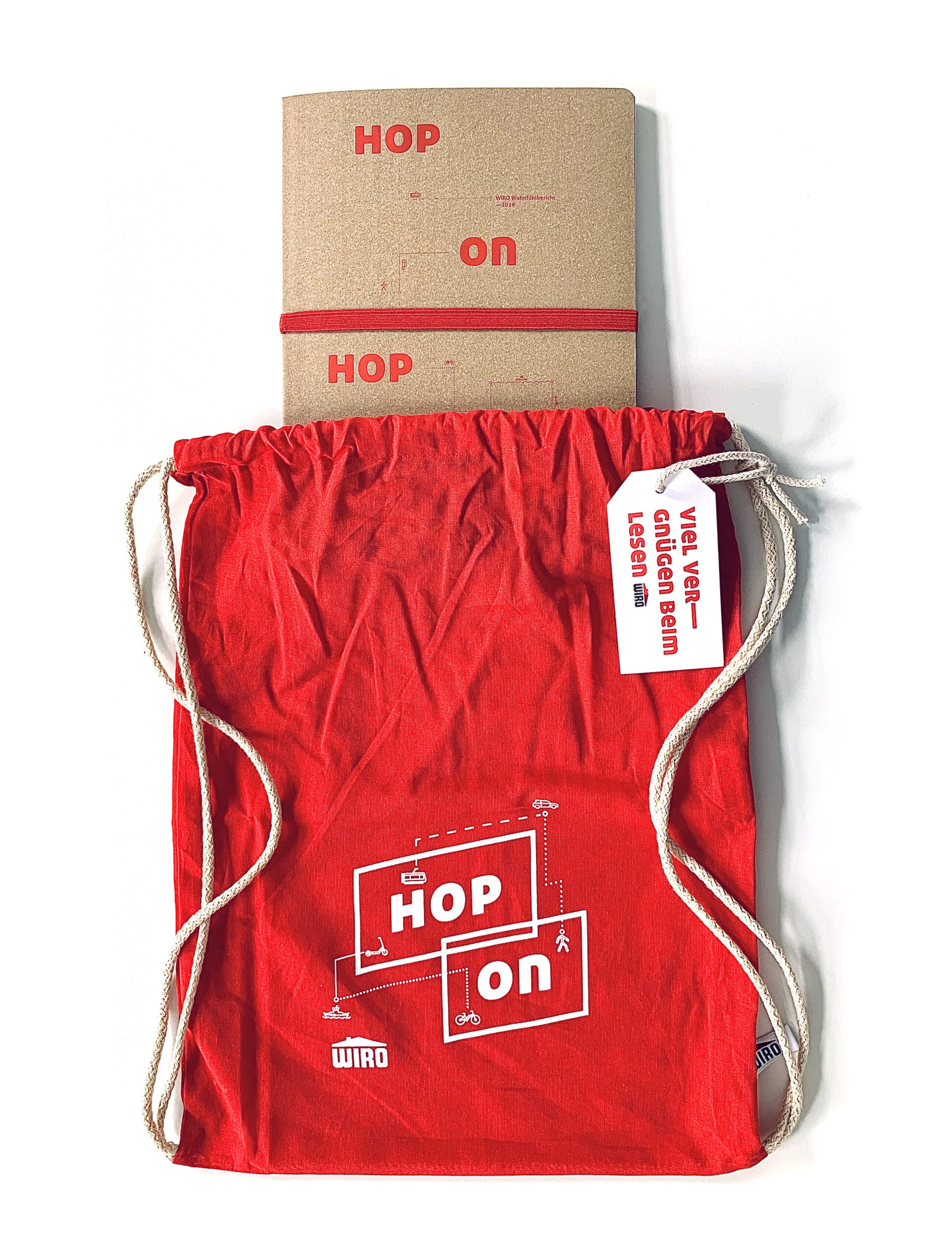 Ein brauner Geschäftsbericht, der in einen roten Turnbeutel mit der Aufschrift "Hop on" gesteckt wird. 